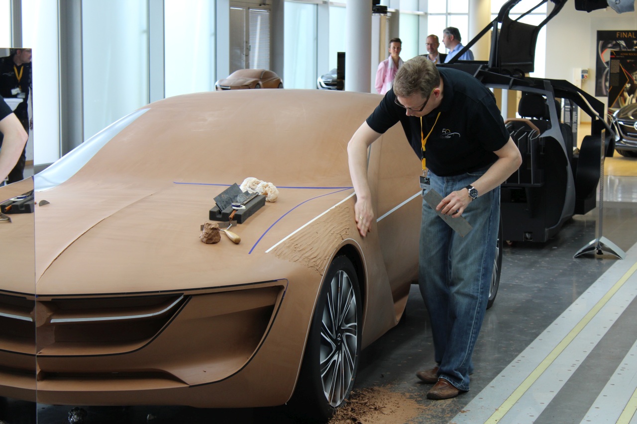 A modeller working on a full-size clay model at the Opel design centre